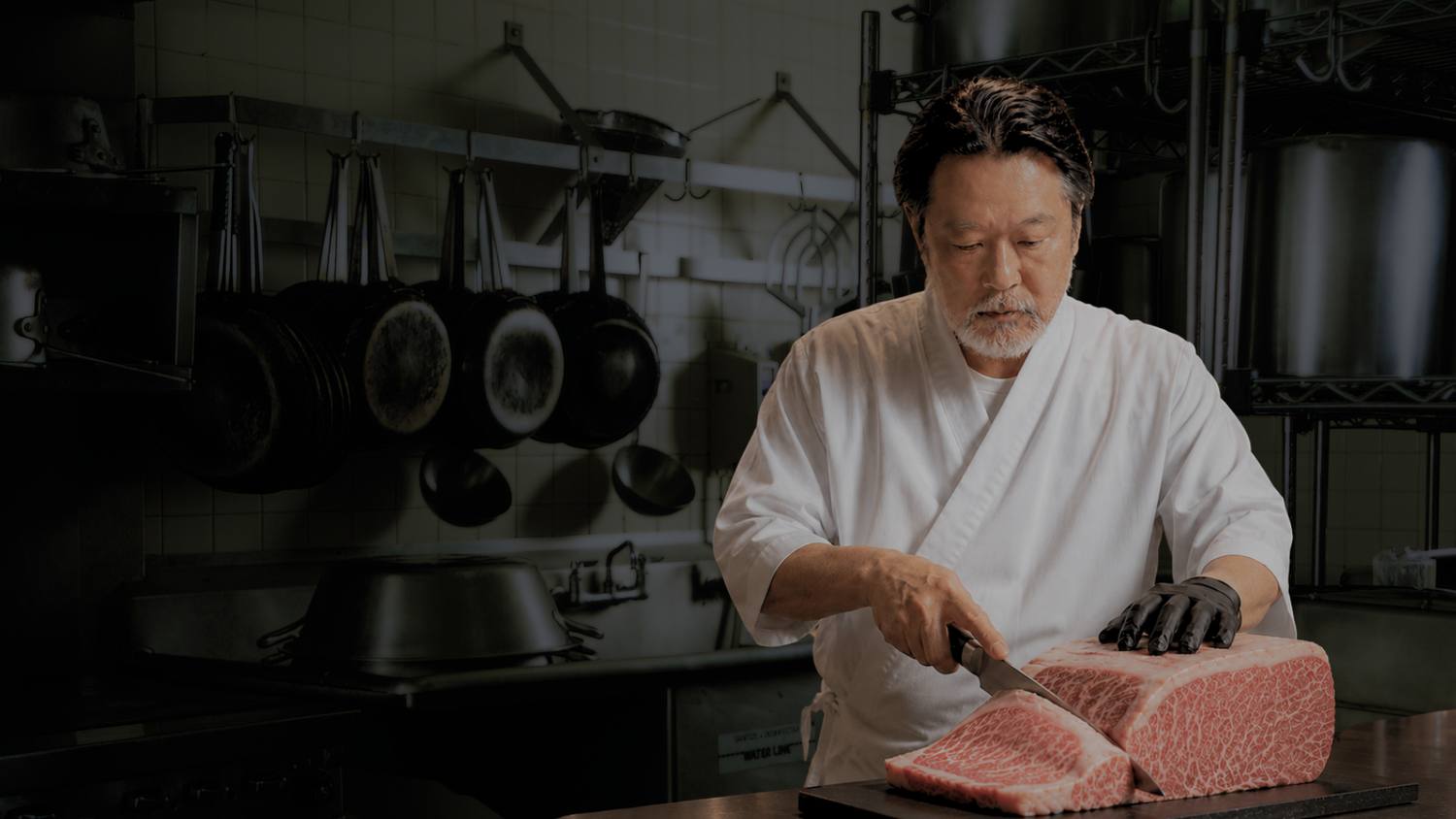 The Japanese owner slicing a block of wagyu