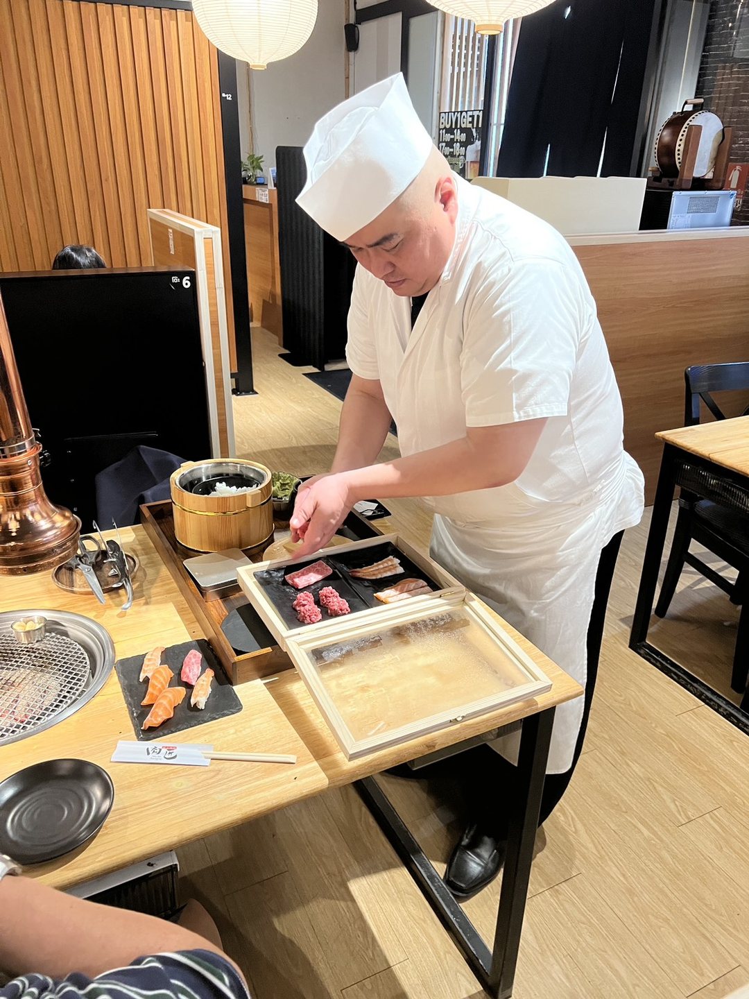 Wagyu and salmon on the chef's tray, pressed sushi on the plate